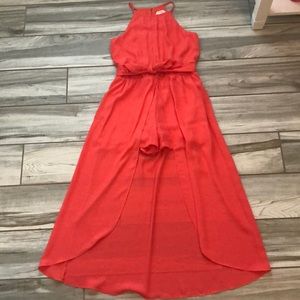 an orange romper with “train”